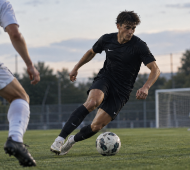 Football player dribbling in a match, showing the performances needed to get a football agent